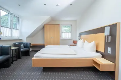 Ein Bett oder Betten in einem Zimmer der Unterkunft Hotel Moselterrasse
