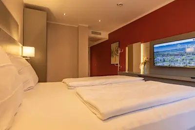 Ein Bett oder Betten in einem Zimmer der Unterkunft MEA HOTEL TRIER