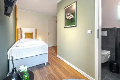 Ein Bett oder Betten in einem Zimmer der Unterkunft Hotel Zweite Heimat Nürburg