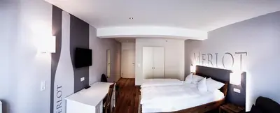 Ein Bett oder Betten in einem Zimmer der Unterkunft Weingut Lehnert-Veit Gutshotel