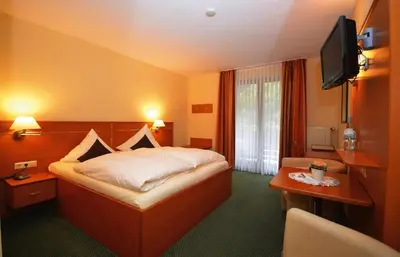 Ein Bett oder Betten in einem Zimmer der Unterkunft Hotel Burgfrieden