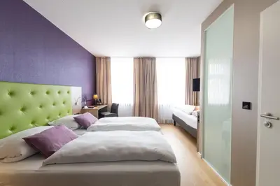Ein Bett oder Betten in einem Zimmer der Unterkunft Hotel Porta Nigra