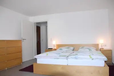 Ein Bett oder Betten in einem Zimmer der Unterkunft Ferienwohnungen Moselterrasse