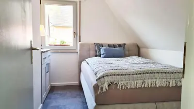 Ein Bett oder Betten in einem Zimmer der Unterkunft Weinstock - klimatisierte Ferienwohnung mit Sonnenterrasse