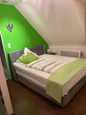 Ein Bett oder Betten in einem Zimmer der Unterkunft Ferienwohnung Rockenbach