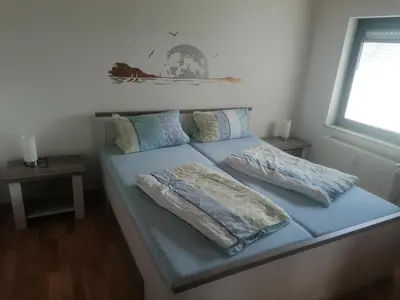 Ein Bett oder Betten in einem Zimmer der Unterkunft Ferienwohnung Moselhöhe