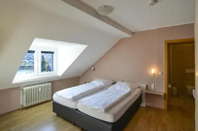 Ein Bett oder Betten in einem Zimmer der Unterkunft Gästehaus Rebstock