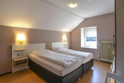 Ein Bett oder Betten in einem Zimmer der Unterkunft Gästehaus Rebstock