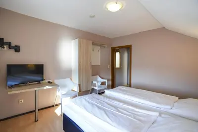 Ein Bett oder Betten in einem Zimmer der Unterkunft Gästehaus Rebstock