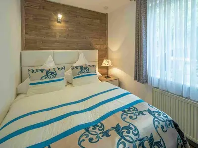 Ein Bett oder Betten in einem Zimmer der Unterkunft Maarpanorama in het Maarberg Resort