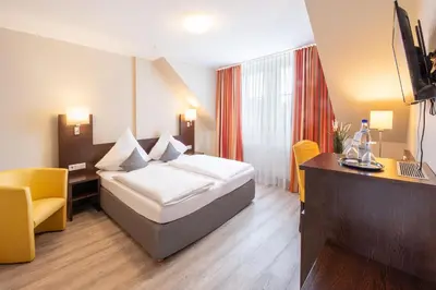 Ein Bett oder Betten in einem Zimmer der Unterkunft Landhotel am Wasserrad