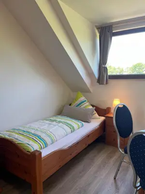 Ein Bett oder Betten in einem Zimmer der Unterkunft Ferienwohnung Burg Maus