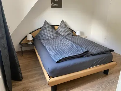 Ein Bett oder Betten in einem Zimmer der Unterkunft Ferienwohnung Retzbachtal