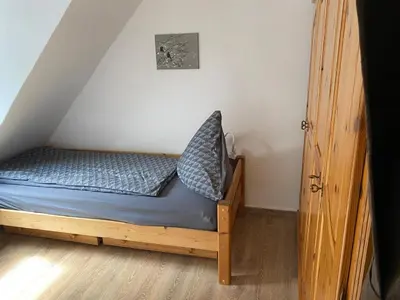 Ein Bett oder Betten in einem Zimmer der Unterkunft Ferienwohnung Retzbachtal