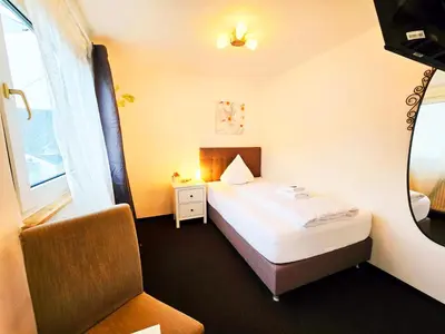Ein Bett oder Betten in einem Zimmer der Unterkunft Hike Inn Hotels by Simonis