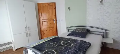 Ein Bett oder Betten in einem Zimmer der Unterkunft Gina`s Ferienwohnung