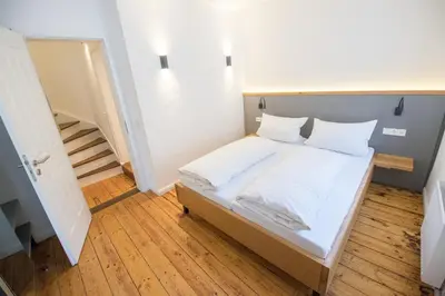 Ein Bett oder Betten in einem Zimmer der Unterkunft BG Living & Hosting - Historisches Ferienhaus 