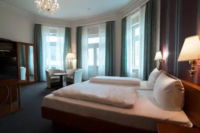 Ein Bett oder Betten in einem Zimmer der Unterkunft Trip Inn Parkhotel Bad Ems