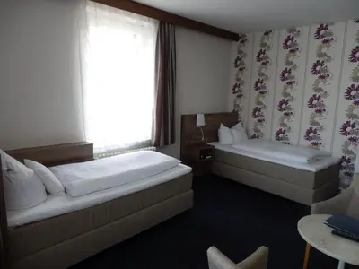 Ein Bett oder Betten in einem Zimmer der Unterkunft Hotel Rheinischer Hof