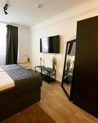 Ein Bett oder Betten in einem Zimmer der Unterkunft City Apartments Trier Suite 5