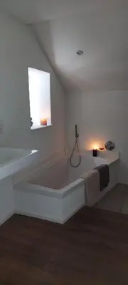 Ein Bett oder Betten in einem Zimmer der Unterkunft Ferienhaus mit Baukulturpreis in der Südeifel - Ferienhaus TRÄNK