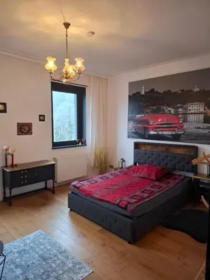 Ein Bett oder Betten in einem Zimmer der Unterkunft Ferienzimmer by Riela im ehemaligem Hotel Schöneck