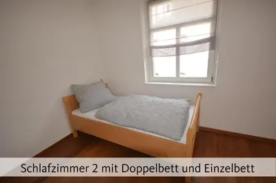 Ein Bett oder Betten in einem Zimmer der Unterkunft Ferienhaus Anno 1912