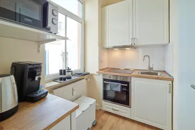 Küche/Küchenzeile in der Unterkunft MARX - Stilvolles Studio-Apartment im Stadtzentrum - ideal für Paare & Geschäftsreisende, Gratis WLAN
