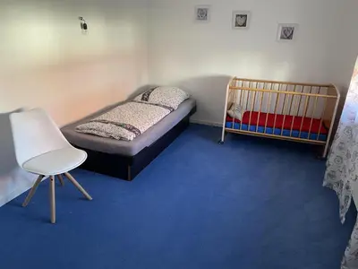 Ein Bett oder Betten in einem Zimmer der Unterkunft Ferienhaus Goethe