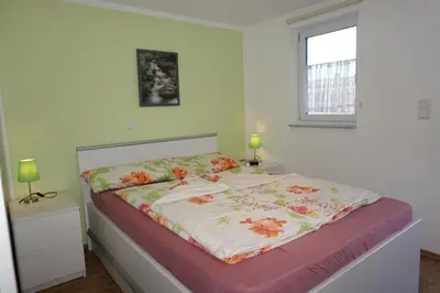 Ein Bett oder Betten in einem Zimmer der Unterkunft Ferienwohnung Am alten Holzweg
