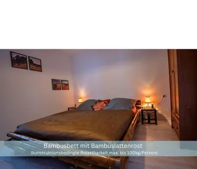 Ein Bett oder Betten in einem Zimmer der Unterkunft Bambuszimmer mit großem Dachgarten im Gästehaus Graf-Schmelzer