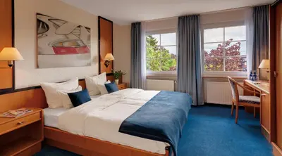Ein Bett oder Betten in einem Zimmer der Unterkunft Motorsport Hotel