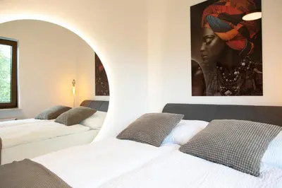 Ein Bett oder Betten in einem Zimmer der Unterkunft MV Römerlodge mit einmaligem Moselpanoramablick