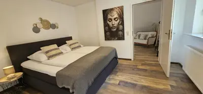 Ein Bett oder Betten in einem Zimmer der Unterkunft MV Römerlodge mit einmaligem Moselpanoramablick