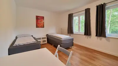 Ein Bett oder Betten in einem Zimmer der Unterkunft Monteurwohnungen in Trier - Parkplatz - Einzelbetten - Waschmaschine und Trockner