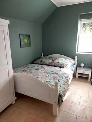 Ein Bett oder Betten in einem Zimmer der Unterkunft Ferienwohnung Beim alten Pfarrhaus