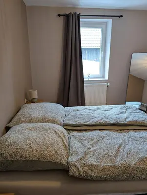 Ein Bett oder Betten in einem Zimmer der Unterkunft Ferienwohnung am Eifelsteig