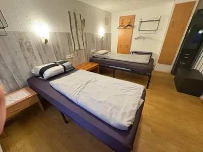 Ein Bett oder Betten in einem Zimmer der Unterkunft Gusenburg H 14 für bis 8 Personen Monteurwohnung