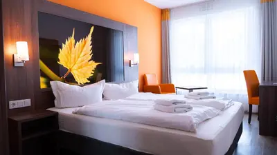 Ein Bett oder Betten in einem Zimmer der Unterkunft Alembra - Wein Style Hotel