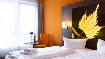 Ein Bett oder Betten in einem Zimmer der Unterkunft Alembra - Wein Style Hotel