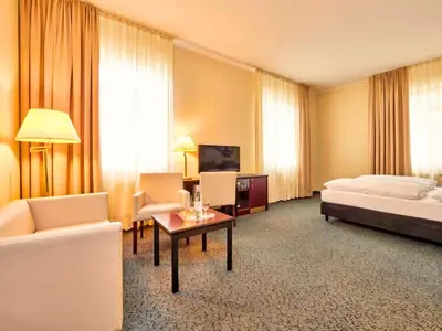 Ein Bett oder Betten in einem Zimmer der Unterkunft Augustiner Hotel