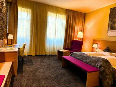 Ein Bett oder Betten in einem Zimmer der Unterkunft Augustiner Hotel
