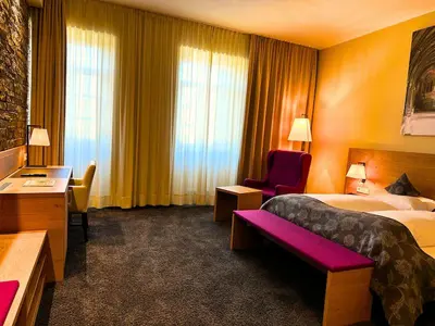 Ein Bett oder Betten in einem Zimmer der Unterkunft Augustiner Hotel