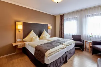 Ein Bett oder Betten in einem Zimmer der Unterkunft Hotel Sankt Maximilian 