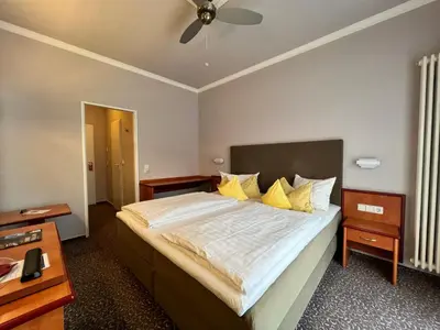 Ein Bett oder Betten in einem Zimmer der Unterkunft Hotel Victoria