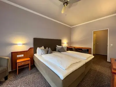 Ein Bett oder Betten in einem Zimmer der Unterkunft Hotel Victoria