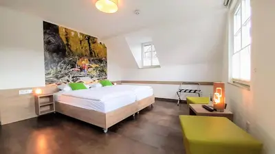 Ein Bett oder Betten in einem Zimmer der Unterkunft Winkelwerkstatt Hotel