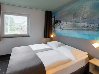 Ein Bett oder Betten in einem Zimmer der Unterkunft B&B Hotel Koblenz-City