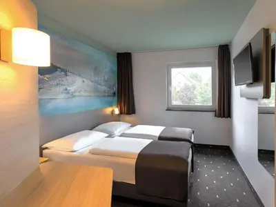 Ein Bett oder Betten in einem Zimmer der Unterkunft B&B Hotel Koblenz-City