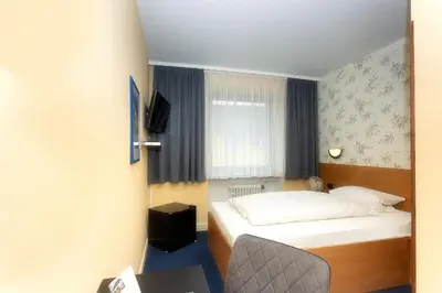 Ein Bett oder Betten in einem Zimmer der Unterkunft Hotel Westrich
